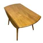 Load image into Gallery viewer, A mid-century modern wooden coffee table with a curved, boat-like top and tapered legs, shown from an elevated angle against a plain white background.
