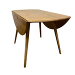 Load image into Gallery viewer, A mid-century modern wooden drop-leaf table with a warm medium-brown finish and tapered legs, shown on a plain white background.
