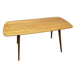Load image into Gallery viewer, A mid-century modern wooden dining table with a light oak grain top and tapered dark brown legs, shown against a plain white background.
