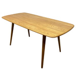 Load image into Gallery viewer, A mid-century modern wooden dining table with a light oak grain tabletop and tapered dark wood legs, shown on a plain white background.
