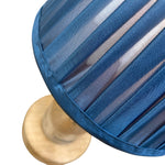 Load image into Gallery viewer, A close-up of a blue pleated fabric lampshade with a light wood base on a white background.
