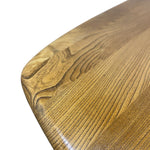 Load image into Gallery viewer, Close-up of a polished wooden tabletop corner showing the natural wood grain and finish against a white background.
