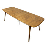Load image into Gallery viewer, A mid-century modern wooden dining table with a rounded rectangular top and tapered legs, shown on a plain white background.
