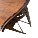 Load image into Gallery viewer, Close-up of a dark brown wooden table corner showing the curved tabletop edge, wood grain, and carved metal legs against a white background.
