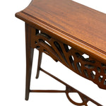 Load image into Gallery viewer, Close-up of a polished medium-brown wooden console table with ornate cutout detailing on the side panel and legs, shown against a plain white background.

