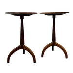 Load image into Gallery viewer, A pair of mid-century modern wooden pedestal side tables with curved tripod bases and circular tops, shown against a plain white background.
