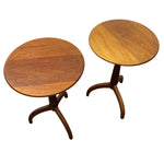 Load image into Gallery viewer, Two round wooden side tables with curved tripod bases, shown on a plain white background.

