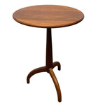 Load image into Gallery viewer, A mid-century modern round wooden table with a three-legged tripod base, shown against a plain white background.
