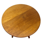 Load image into Gallery viewer, A round wooden coffee table with a warm medium-brown finish and visible wood grain, shown from a top-down angle on a white background.
