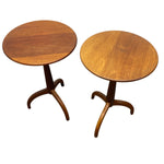 Load image into Gallery viewer, Two round wooden side tables with curved tripod bases, shown on a plain white background.
