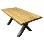 Load image into Gallery viewer, A live-edge wooden dining table with a natural oak top and dark metal X-shaped legs, shown on a plain white background.
