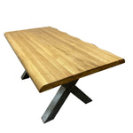 Load image into Gallery viewer, A live-edge oak dining table with a natural wood top and a dark metal X-shaped base, shown on a plain white background.
