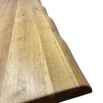 Load image into Gallery viewer, Close-up of a live-edge wooden table showing the natural wood grain and polished finish on a white background.

