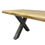 Load image into Gallery viewer, A live-edge wooden dining table with a natural oak top and a dark gray concrete or metal X-shaped base, shown on a plain white background.
