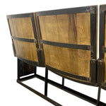 Load image into Gallery viewer, A close-up of a rustic wooden headboard with curved panel designs and heavy black metal framing and support beams, shown against a plain white background.
