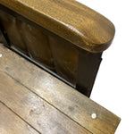 Load image into Gallery viewer, Close-up detail of a wooden armchair showing the polished brown wooden armrest, dark metal frame, and weathered wooden seat slats against a white background.

