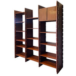 Load image into Gallery viewer, A mid-century modern wooden bookcase with three tall shelving units, featuring a warm reddish-brown wood finish and a darker brown frame, shown against a plain white background.

