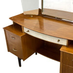 Load image into Gallery viewer, Mid-century modern wooden dressing table with a curved top, two drawers on the left, an open shelf, and a mirror mounted above on a white background.
