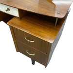 Load image into Gallery viewer, Mid-century modern wooden desk with a warm brown wood grain finish, featuring two drawers with brass handles and a white drawer pull on the top left, shown against a plain white background.
