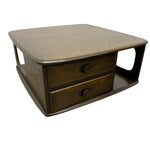 Load image into Gallery viewer, A mid-century modern wooden coffee table or side table with two drawers, featuring a rounded rectangular top, dark wood grain, and open side cutouts, shown on a plain white background.
