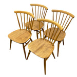 Load image into Gallery viewer, Four wooden dining chairs with spindle backs and rounded square seats, shown on a plain white background.
