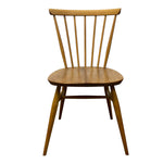 Load image into Gallery viewer, A mid-century modern wooden dining chair with a spindle back, round seat, and tapered legs, shown against a plain white background.
