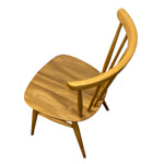 Load image into Gallery viewer, A light natural wood dining chair with a rounded square seat, curved backrest, and tapered legs, shown from an elevated angle on a solid white background.
