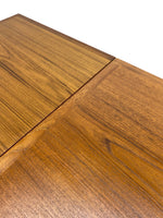 Load image into Gallery viewer, Close-up of a wooden table surface showing a warm medium-brown wood grain finish and a visible joint seam, photographed against a white background.
