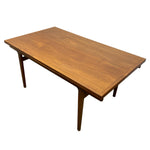 Load image into Gallery viewer, A mid-century modern wooden dining table with a warm medium-brown teak wood finish, featuring tapered legs and a clean rectangular top, shown on a solid white background.
