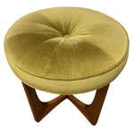 Load image into Gallery viewer, A round tufted ottoman stool with a textured green fabric cushion and a mid-century wooden star base, shown against a plain white background.
