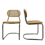 Load image into Gallery viewer, Two vintage-style cantilever dining chairs with woven cane seats and backs, shown from front and side angles on a white background.
