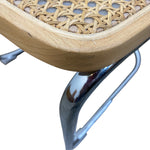 Load image into Gallery viewer, Close-up of a chair seat with a light natural wood frame, woven cane or rattan panel, and curved polished metal legs on a white background.
