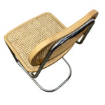 Load image into Gallery viewer, A modern folding chair with a light natural wood frame, a woven cane seat, and a polished chrome metal tubular frame, shown from an elevated angle on a white background.
