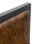 Load image into Gallery viewer, Close-up detail of a chair or upholstered furniture corner, showing a brown and black cowhide-style seat or back with a dark charcoal frame on a white background.
