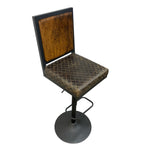 Load image into Gallery viewer, A vintage-style bar stool with a square backrest and seat upholstered in distressed brown textured fabric with a diamond pattern, supported by a black metal pedestal base with a footrest.
