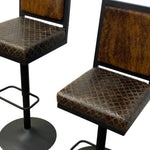 Load image into Gallery viewer, Two modern bar stools with textured brown faux-cowhide upholstered seats and backrests, black metal frames, and round black bases, shown on a white background.
