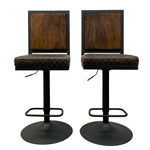 Load image into Gallery viewer, Two matching bar stools with dark brown textured upholstered seats and square backrests, set on black adjustable pedestal bases with circular footrests, shown against a plain white background.
