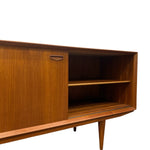 Load image into Gallery viewer, A mid-century modern wooden sideboard cabinet with a warm walnut finish, featuring a sliding door, open shelving, and tapered legs, shown against a plain white background.
