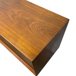 Load image into Gallery viewer, A close-up of a wooden furniture piece, showing the polished warm brown wood grain and beveled corner on a plain white background.
