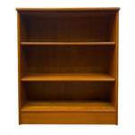Load image into Gallery viewer, A three-tier wooden bookcase with a warm honey-amber finish, shown against a plain white background.

