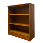 Load image into Gallery viewer, A three-tier wooden bookcase with a warm medium-brown finish, shown from a three-quarter angle against a plain white background.
