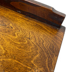 Load image into Gallery viewer, Close-up of a dark brown wooden table corner showing the wood grain on the tabletop and apron, photographed against a white background.
