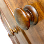 Load image into Gallery viewer, A close-up of a polished wooden dresser knob mounted on a warm brown wood cabinet door, with a second knob visible in the background.
