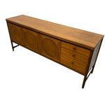 Load image into Gallery viewer, Mid-century modern wooden sideboard with three circular carved doors on the left and three drawers on the right, shown on a plain white background.
