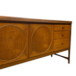 Load image into Gallery viewer, Mid-century modern wooden sideboard with two cabinet doors featuring large circular inlays, three drawers on the right with small round knobs, and tapered metal legs, shown against a plain white background.
