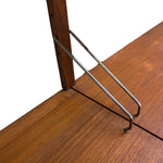 Load image into Gallery viewer, Close-up of a wooden table corner with a medium brown wood grain surface, a vertical wooden post, and two angled metal hairpin legs in a silver finish against a white background.

