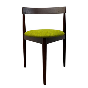 Chair with green cushioned seat and dark wooden frame on a white background