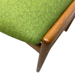 Load image into Gallery viewer, Close-up of a green upholstered chair with wooden armrest and leg.
