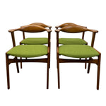 Load image into Gallery viewer, Four wooden chairs with green cushioned seats on a white background
