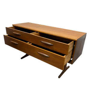 Wooden dresser with multiple open drawers on a white background